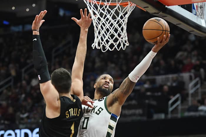 Milwaukee Bucks guard Damian Lillard (0) drives to the basket against Cleveland Cavaliers guard Max Strus (1)